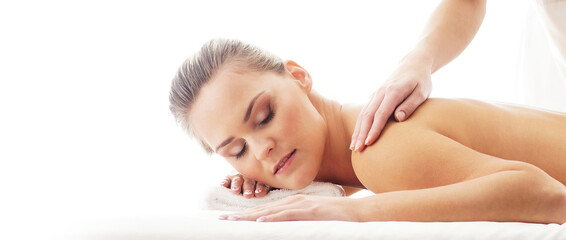 Young, beautiful and healthy woman in spa salon. Traditional massage therapy and skin care treatments.