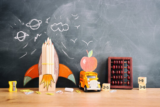 education. Back to school concept over wooden table and blackboard background