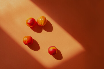 Top down flat lay orange colorful shot  peaches and shadow summer food concept