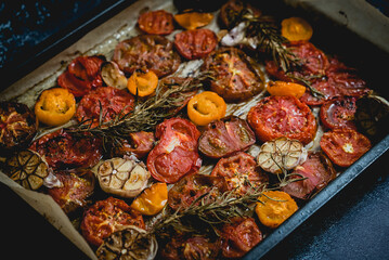 Metal tray with roasted with garlic and herbs different color and kinds tomatoes