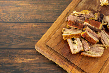 bovine ribs, roasted and sliced on a cutting board with copy space