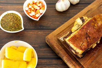 traditional brazilian barbecue beef rib, with bone and side dishes, top view