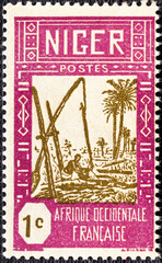 NIGER - CIRCA 1926-1940: stamp printed by Niger shows Drawing Water from Well.
