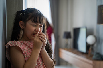 Little Girl Unhappy And Crying Fighting Parents Behind,Wife husband relations concept.