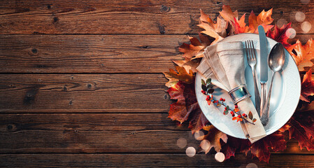 Thanksgiving autumn table setting with colorful fall leaves