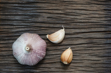 Garlic or Allium sativum on an old wood background.top view.