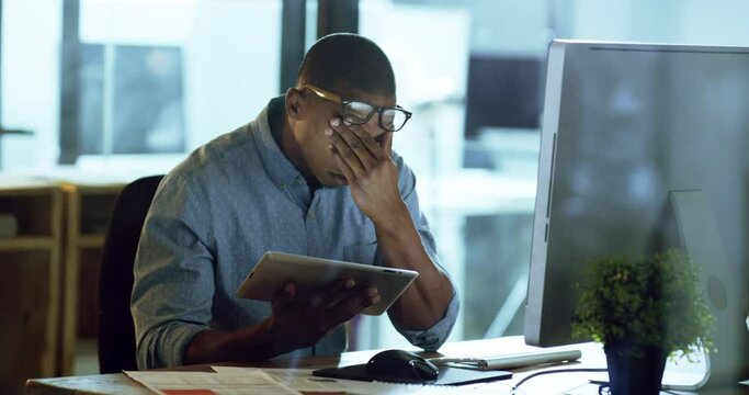 Stress, anxiety and burnout with a business man working on a tablet in his office for overtime at night. Depression, tired and headache with a male worker struggling with mental health and compliance