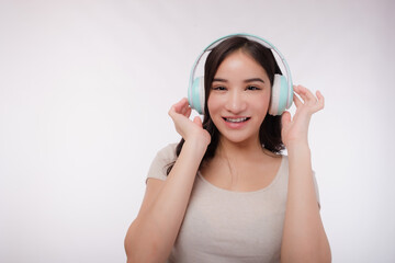 Smiling Asia young woman listening to the podcast e-book music song singer rock band in headphones earphones, choosing sound track on cellphone isolated in white background be happy