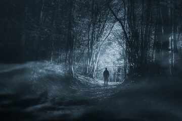 man in dark woods at night