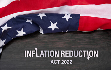 Fototapeta na wymiar Inflation reduction act of 2022 concept with United States flag on top.