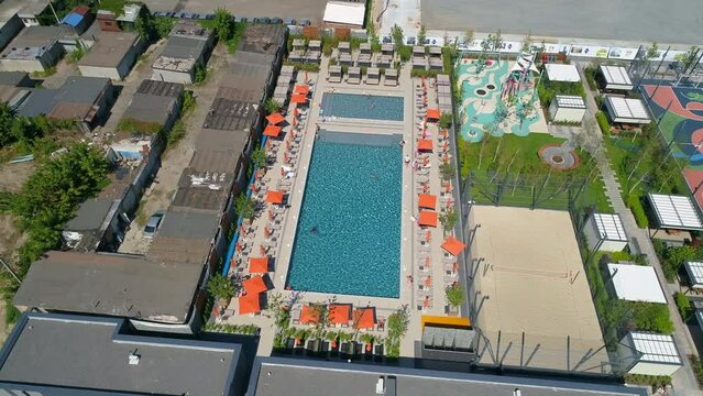 Drone aerial view people swim in the pool on the territory modern Residential complex Faina Town. Construction of residential premises. Kyiv capital of Ukraine