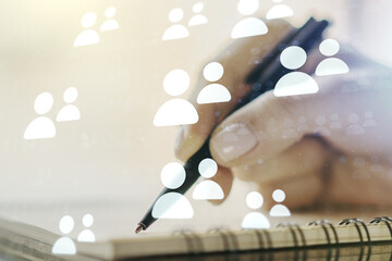 Double exposure of social network icons concept with woman hand writing in notepad on background. Networking concept