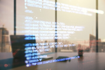 Double exposure of abstract programming language and modern desktop with laptop on background, research and development concept