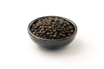 Black pepper or peppercorns in ceramic bowl isolated on white background.