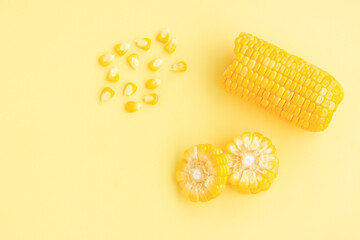 Yellow corn cobs slice with seeds on yellow background