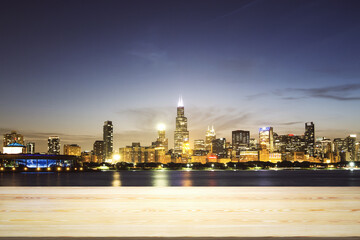 Blank tabletop made of wooden planks with beautiful Chicago cityscape at evening on background, mockup