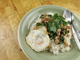 Stir-fried gourd with minced pork on rice and fried egg