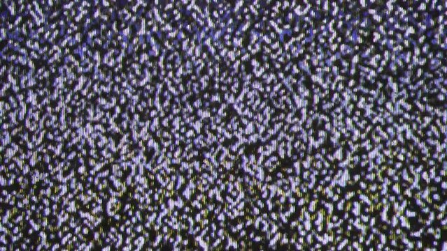 Close up view at a plasma tv while showing television white noise.