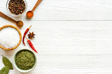 Cooking ingredients - colorful spices and herbs in bowls, top view