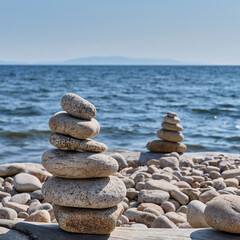 Fototapeta na wymiar Pyramids of stones on shore of Kultuk Bay, Lake Baikal, Zabaikalsky National Park, Russia.