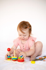  Emotional cute Baby is playing. Infant learning and development. Wooden eco-friendly educational toys. Montessori system.