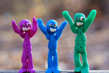 Obraz premium Figures of three happy zombies in close-up. Joyful monsters.