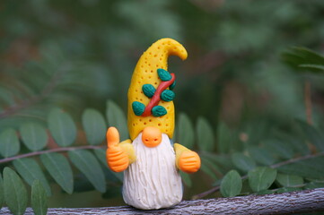 A figure of a joyful gnome. Objects made of plasticine. Fairy-tale characters.