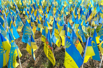 Kyiv, Ukraine, August 2022: - Lots national flags of ukraine with names of killed soldiers in war against Russian aggressors 2022 on Khreshchatyk street. One flag with name - one hero. - 525322589