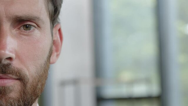 Male half face part front view close up serious man bearded adult 40s millennial looking at camera opening eye blink problem with eyesight vision laser correction operation healthcare ophthalmology