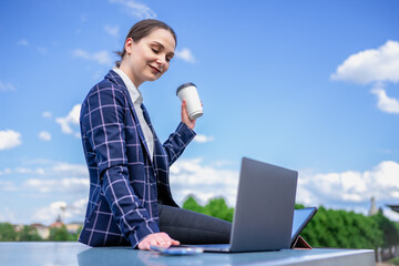 Businesswoman using devices on street