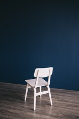 blue chair on wooden wall