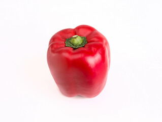 Ripe red bell pepper with a green stem, isolated. Single red pepper, organic vegetable on a white background.