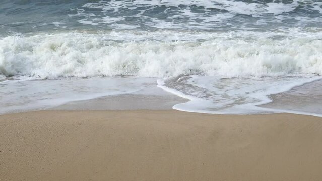 Ocean background live wallpaper. Stormy dark water white sea foam empty sand beach crashing waves
