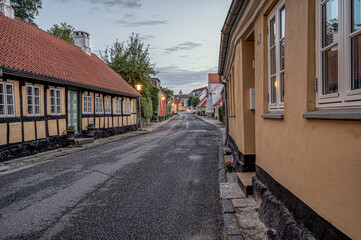 street in the small danish town Mariager at sunset, leading up to the church
