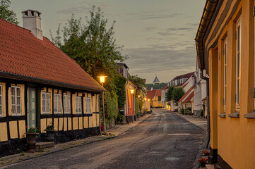 Picturesque road in the evening ligt to the church in Mariager