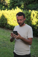 adult male performing transactions on the phone