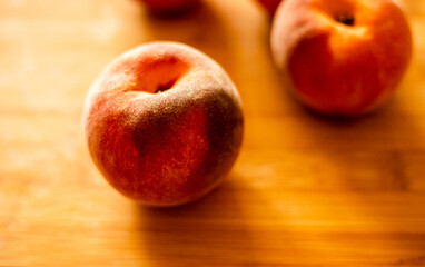 Ripe peaches on wooden board close up
