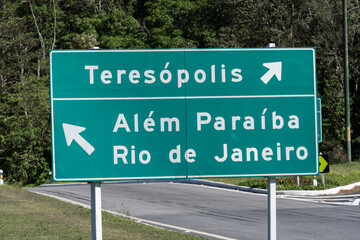 Fototapeta premium Road to Teresópolis, Rio de Janeiro, Brazil. Mountain region of the state. Signposts, cars on the highway. Region with a lot of nature. Sunny day
