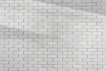 Brick white wall with shadow background. White stone brickwork.