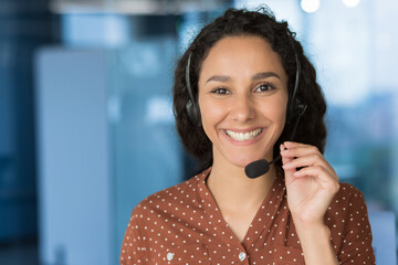Close up photo portrait of young beautiful hispanic woman, business woman smiling and looking at camera, receptionist using headset for video call, happy and successful call center worker - Powered by Adobe