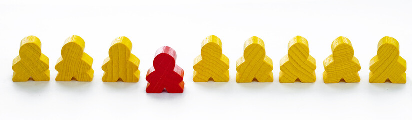 The wooden figures stand in line, and the red figure as a leader stands in front. Chief at work, leadership and personnel management,  Business coach concept.