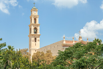 Obraz premium old christian church against bright blue sky on a summer day, st. Peter's churge, Jaffo, Israel