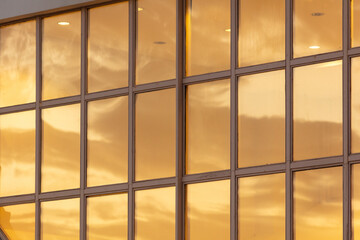 The windows of the house are in the rays of the golden sunset.