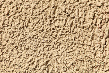 Decorative plaster on the wall of the house as an abstract background.