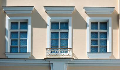 Windows on the wall of an old high-rise building.