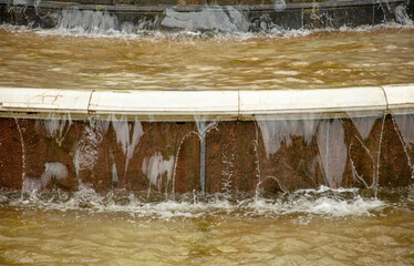 Splashes of water in the fountain in the park.