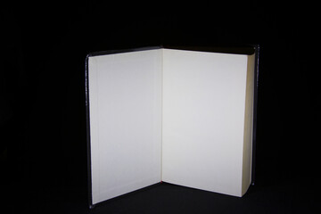 Open book with blank pages on dark background