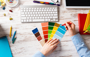 Interior designer choosing colors from swatches