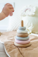 Environmentally friendly plastic toys for babies. Modern natural wooden pyramid with rings
