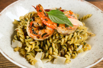 Fusilli pasta spicy with grilled shrimps in a ceramic plate. Fusion food style